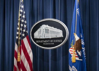 A sign for the Department of Justice is seen ahead of a news conference with Michael Sherwin, acting US attorney for the District of Columbia, and Steven D'Antuono, head of the Federal Bureau of Investigation (FBI) Washington field office, at the US Department of Justice in Washington, DC, on January 12, 2021. (SARAH SILBIGER/POOL/AFP via Getty Images)