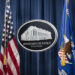 A sign for the Department of Justice is seen ahead of a news conference with Michael Sherwin, acting US attorney for the District of Columbia, and Steven D'Antuono, head of the Federal Bureau of Investigation (FBI) Washington field office, at the US Department of Justice in Washington, DC, on January 12, 2021. (SARAH SILBIGER/POOL/AFP via Getty Images)