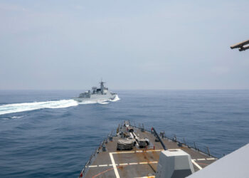 The Arleigh Burke-class guided-missile destroyer USS Chung-Hoon is observing the Chinese PLA Navy vessel Luyang III (top) while on a transit through the Taiwan Strait with the Royal Canadian Navy's HMCS Montreal on June 3, 2023. (Andre T. Richard/U.S. Navy/AFP/Getty Images)