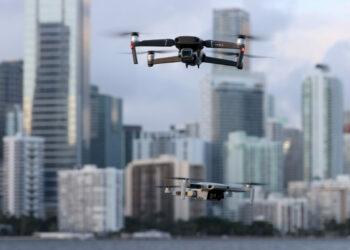 A DJI Mavic 2 Pro and DJI Mavic Mini made by the Chinese drone maker fly near each other in Miami, Florida, on Dec. 15, 2021. (Joe Raedle/Getty Images)