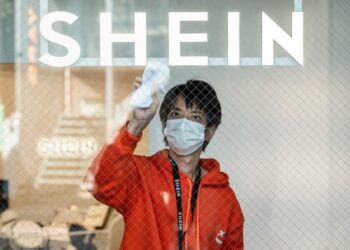 A man cleaning the windows of the first permanent showroom of Chinese online fast fashion giant Shein, during a media preview in Tokyo on Nov. 10, 2022. (Richard Brooks/AFP via Getty Images)