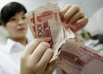 A Chinese bank worker counts stacks of 100-yuan notes at a bank in Huaibei, in eastern China's Anhui Province in this file photo taken on Aug. 4, 2010. (STR/AFP/Getty Images)