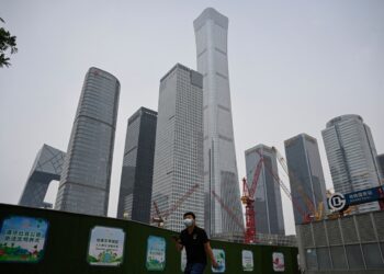 A man walks past the Central Business District in Beijing on May 31, 2023. (Jade Gao/AFP via Getty Images)